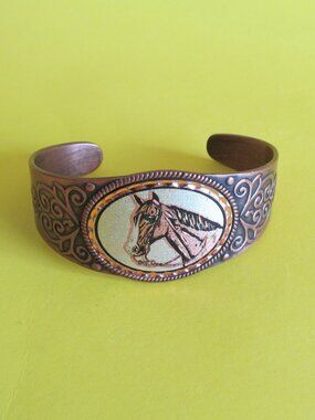 Copper cuff bracelet with horse head design